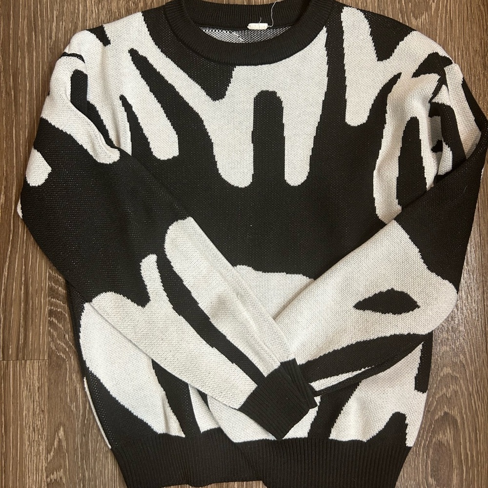 Boys white and black sweater.